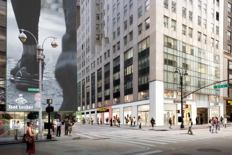 Image of new york street corner. Cross streets read W41st st and Broadway. Footlocker and Savaux store fronts shown.